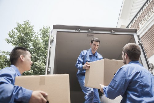 Person organizing storage boxes in a modern Merton storage facility