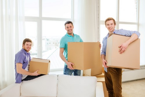 Careful movers organising packing materials for a house move in Merton